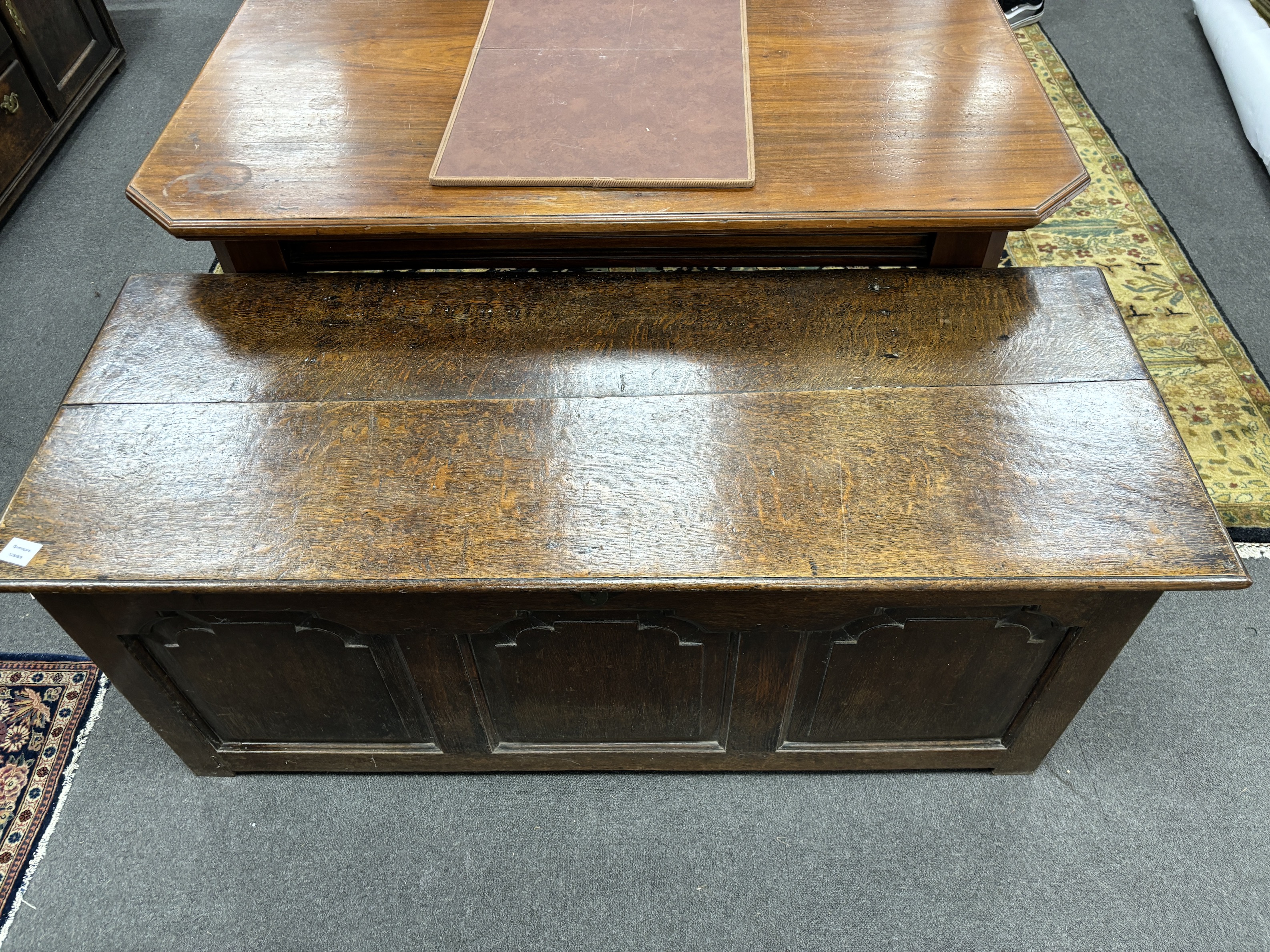 A mid 18th century oak coffer, with a triple arched fielded panelled front, width 146cm, depth 66cm, height 60cm